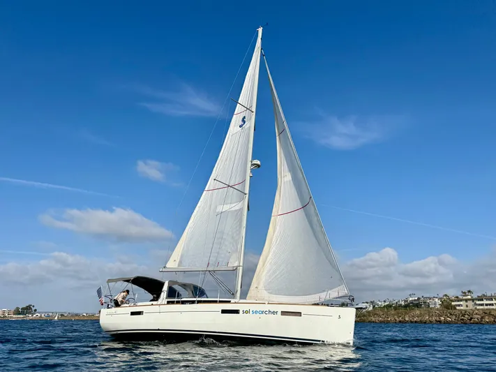 Sol Searcher Yacht Photos Pics 2013 Beneteau Oceanis 41 sailboat on open water under clear blue sky.