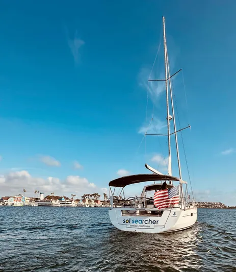 Sol Searcher Yacht Photos Pics 2013 Beneteau Oceanis 41 sailboat on calm water under clear blue sky.