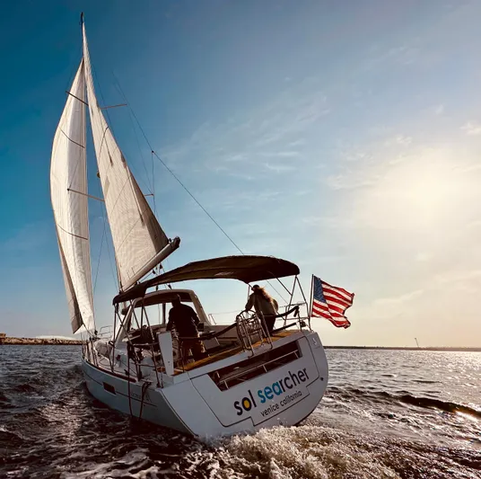 Sol Searcher Yacht Photos Pics Sailing yacht Beneteau Oceanis 41, 2013 model, cruising with American flag in the breeze.