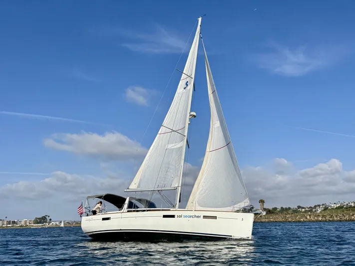 Sol Searcher Yacht Photos Pics 2013 Beneteau Oceanis 41 sailboat cruising on open water under clear blue skies.