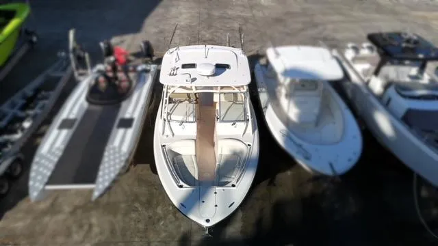  Yacht Photos Pics 2013 Grady-White Freedom 335 boat docked among other vessels.