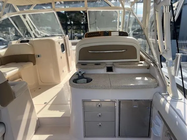  Yacht Photos Pics 2013 Grady-White Freedom 335 boat interior with seating and kitchenette area.