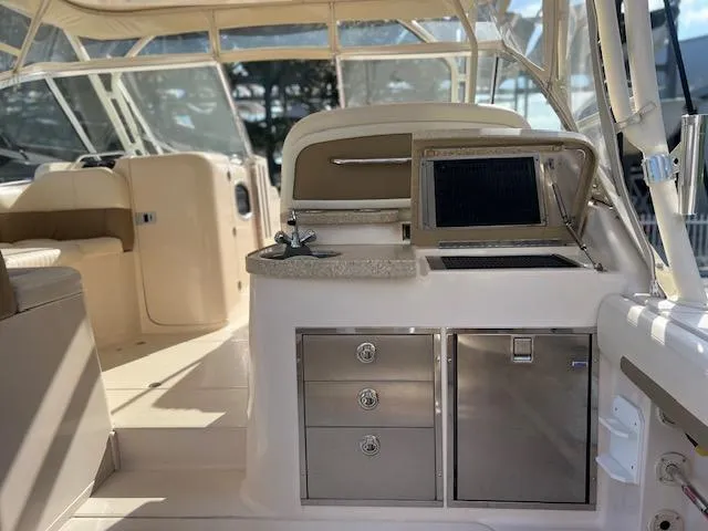  Yacht Photos Pics 2013 Grady-White Freedom 335 boat interior with helm, seating, and storage compartments.