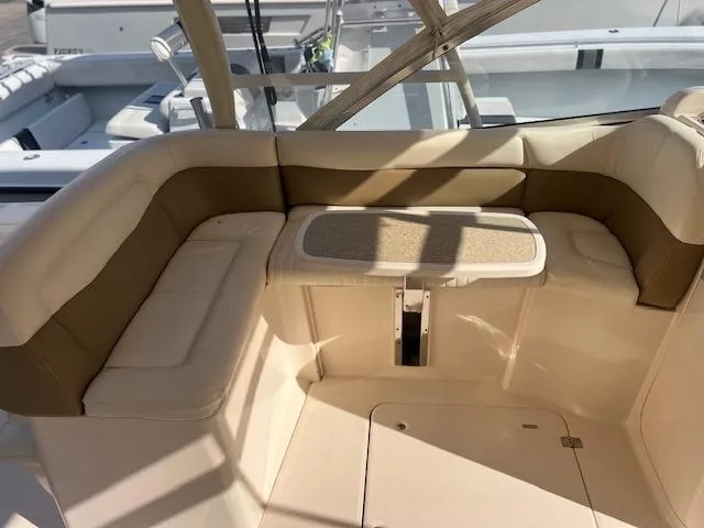  Yacht Photos Pics 2013 Grady-White Freedom 335 boat interior with cushioned seating and table.