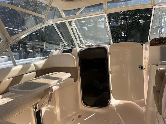  Yacht Photos Pics 2013 Grady-White Freedom 335 boat interior with seating and open cabin door.