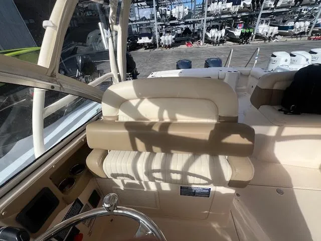  Yacht Photos Pics Interior of 2013 Grady-White Freedom 335 boat with beige seating and steering wheel.