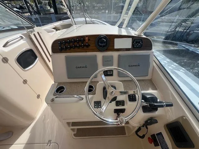  Yacht Photos Pics 2013 Grady-White Freedom 335 boat dashboard with Garmin navigation systems and steering wheel.