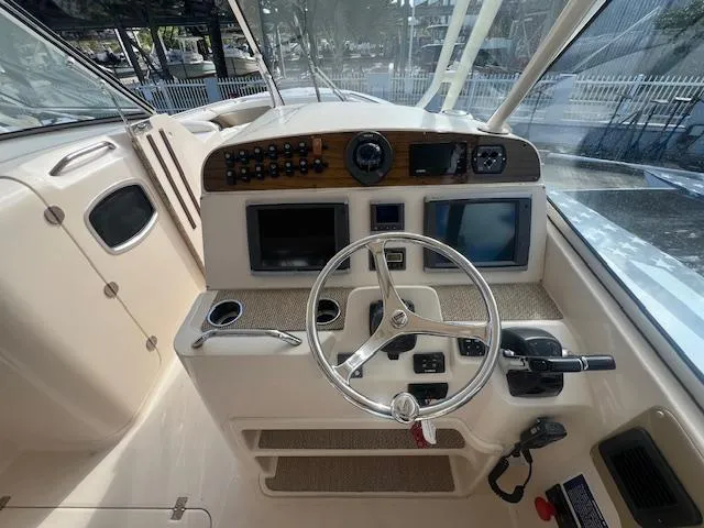  Yacht Photos Pics 2013 Grady-White Freedom 335 boat dashboard with steering wheel and navigation controls.