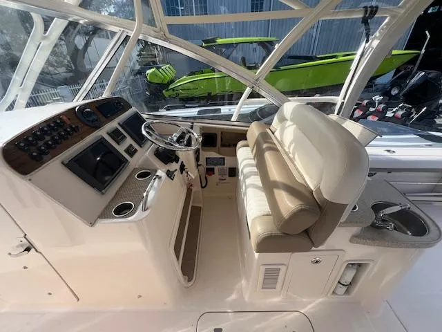  Yacht Photos Pics 2013 Grady-White Freedom 335 boat interior with helm, seating, and controls.