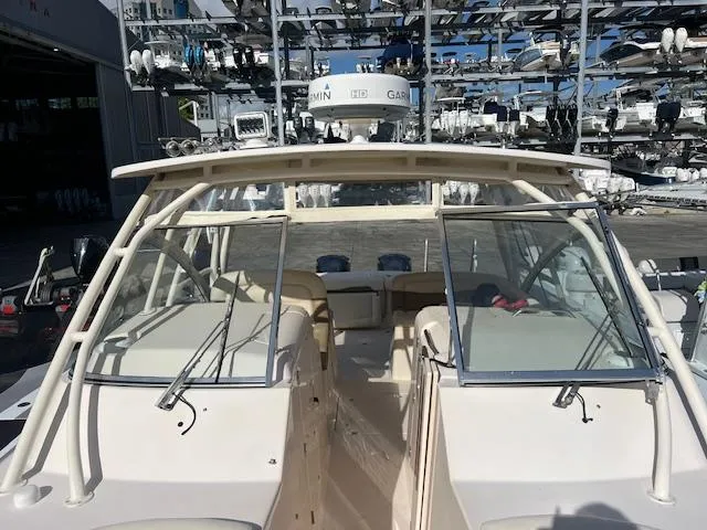  Yacht Photos Pics 2013 Grady-White Freedom 335 boat docked in a marina with multiple vessels.