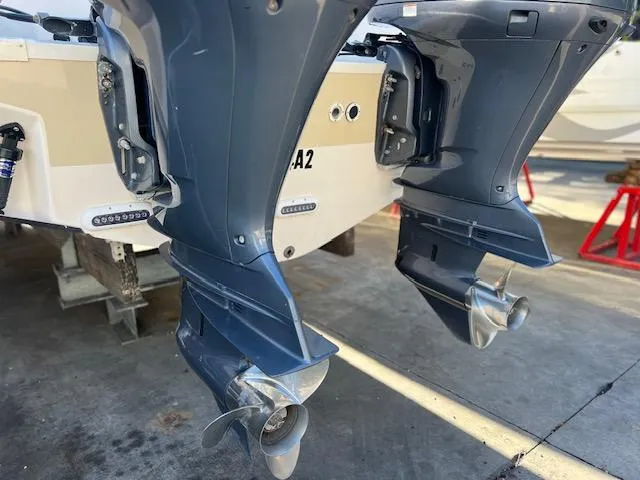  Yacht Photos Pics Twin outboard motors on a 2013 Grady-White Freedom 335 boat, docked on a concrete surface.