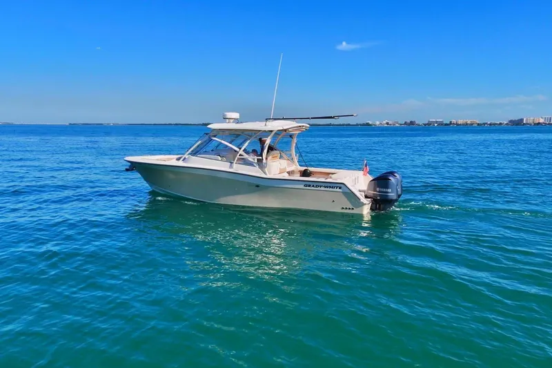  Yacht Photos Pics 2013 Grady-White Freedom 335 boat cruising on clear blue water under a sunny sky.