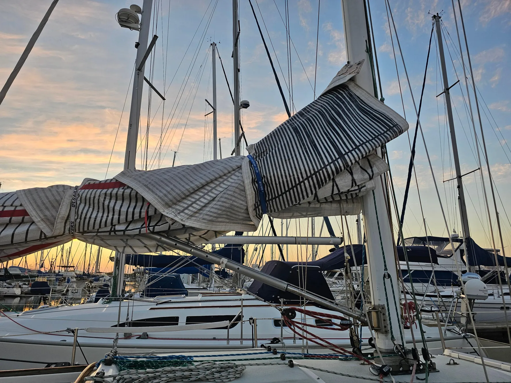 Sailboat Schock NY 36, 1984 model, docked at sunset with sails furled.