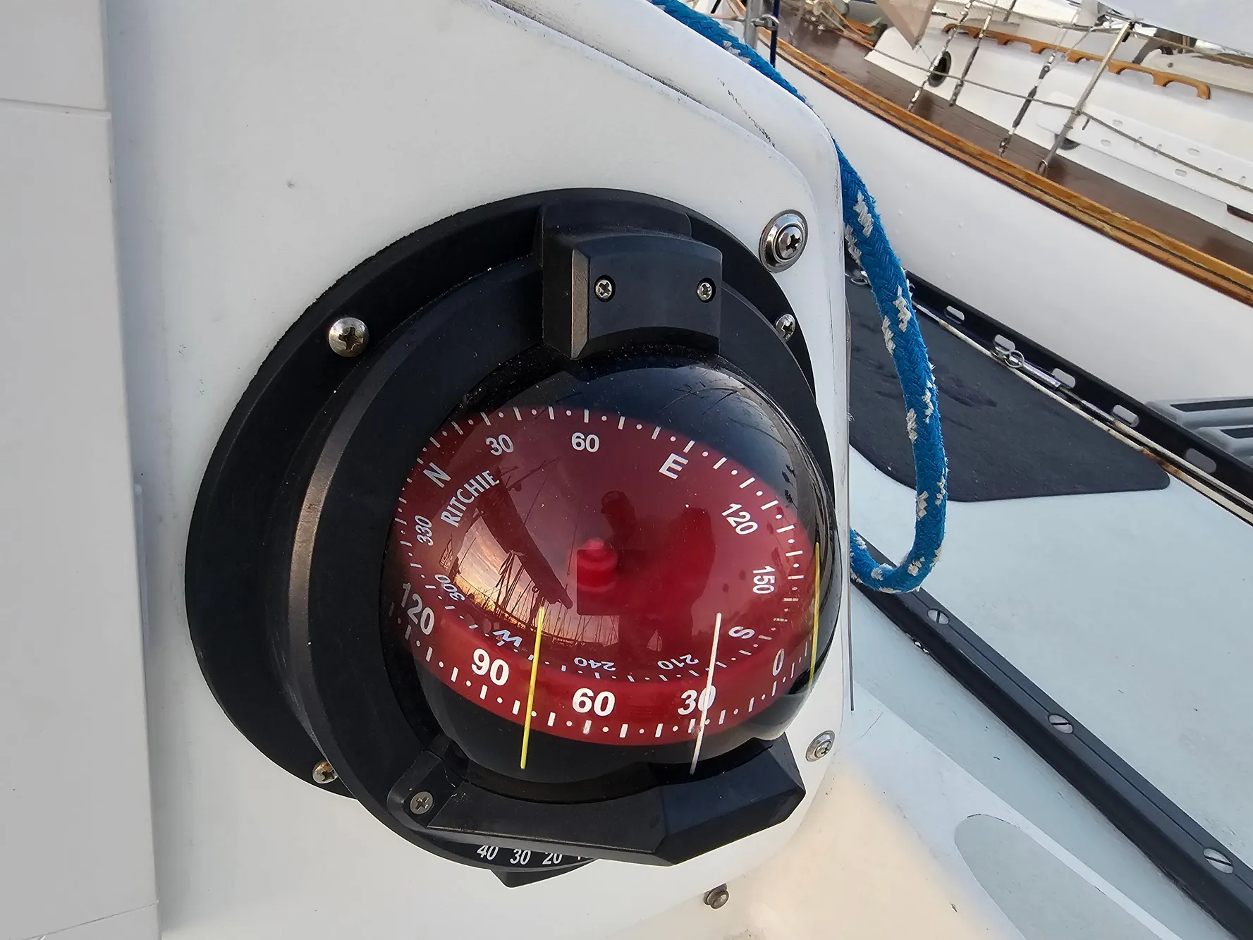 Compass on 1984 Schock NY 36 sailboat, featuring a red Ritchie compass.