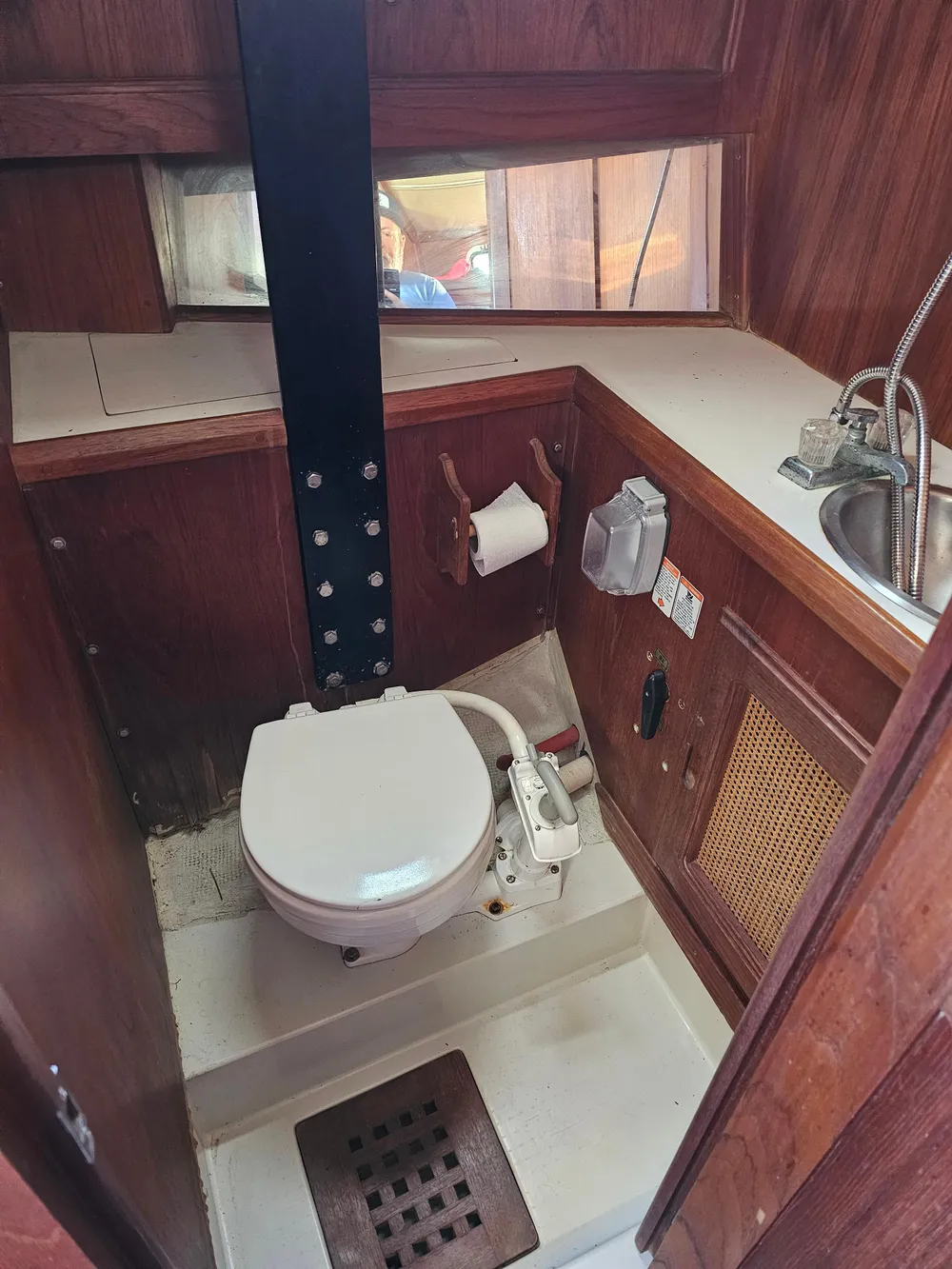 1984 Schock NY 36 boat bathroom with toilet, sink, and wooden interior.