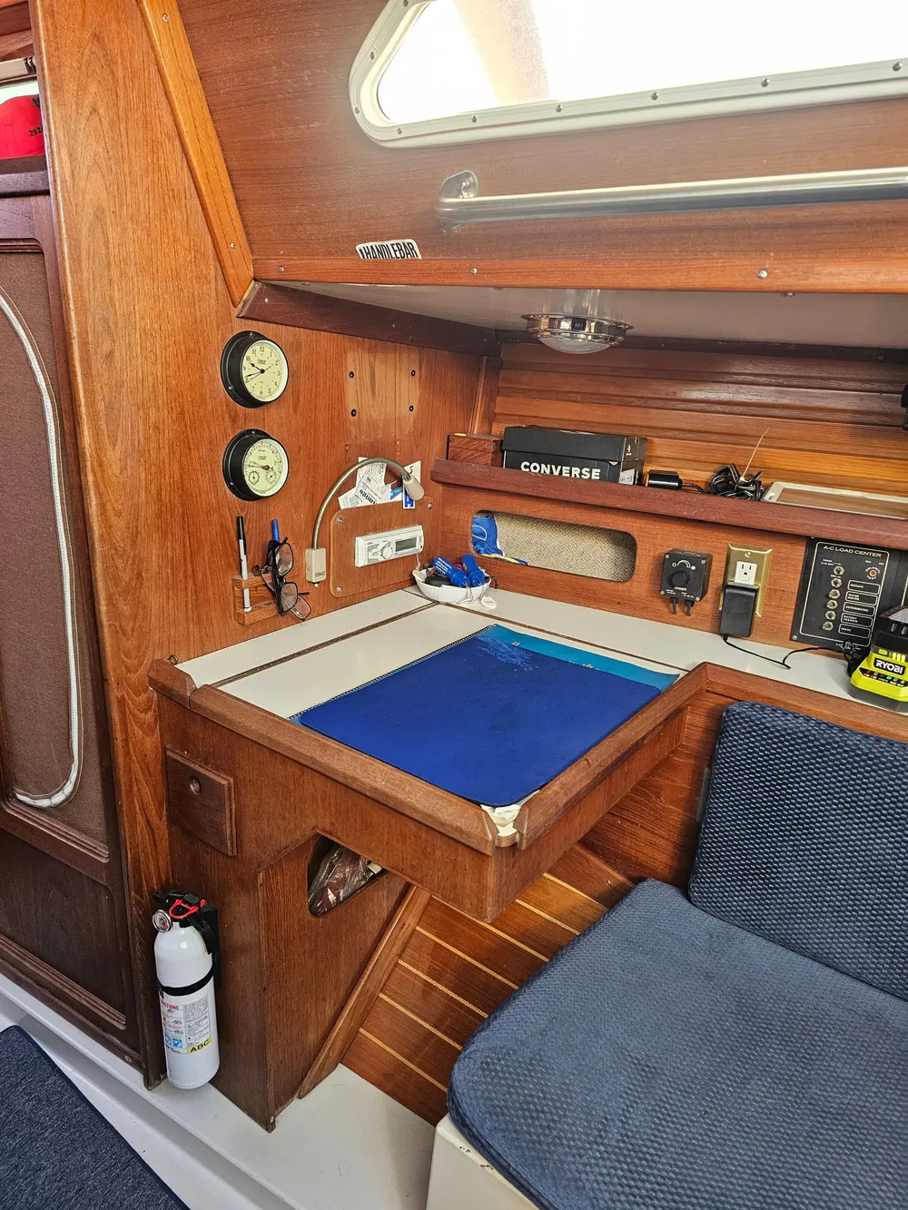 Interior of a 1984 Schock NY 36 sailboat with navigation station and wooden cabinetry.