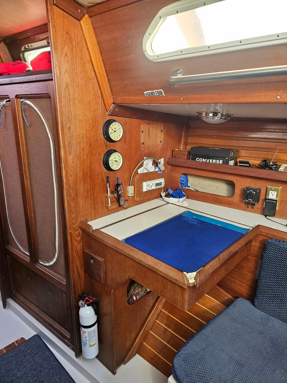 1984 Schock NY 36 sailboat interior with navigation station and wooden cabinetry.
