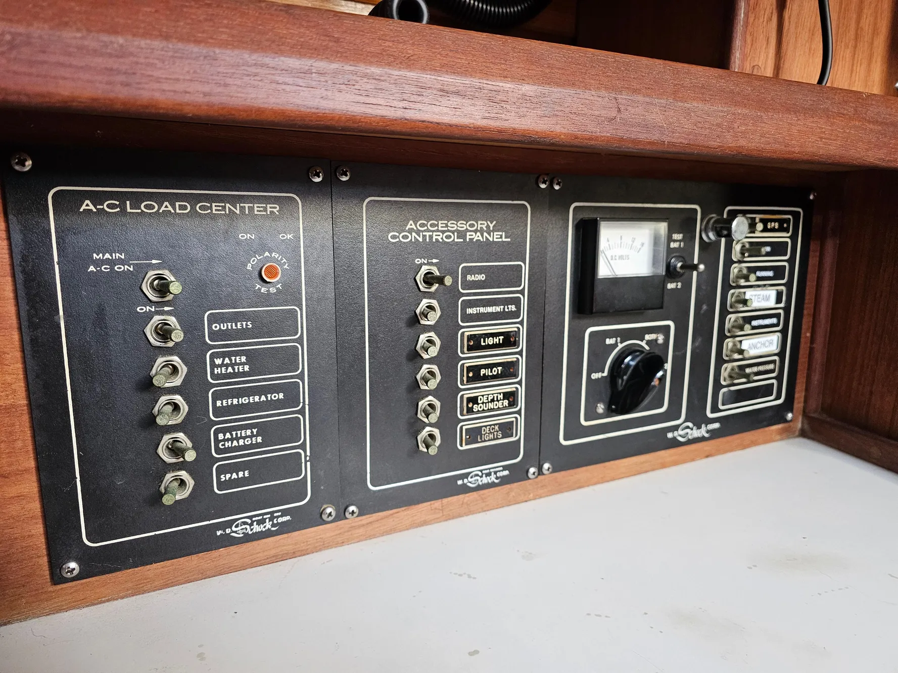 Control panel of a 1984 Schock NY 36 sailboat, featuring A-C load center and accessory controls.