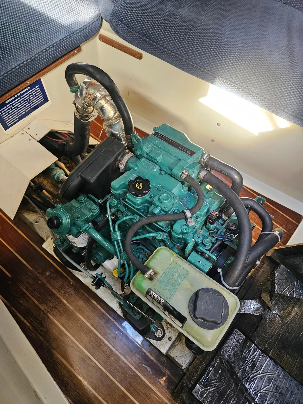 Engine of a 1984 Schock NY 36 sailboat, showing detailed components and layout.
