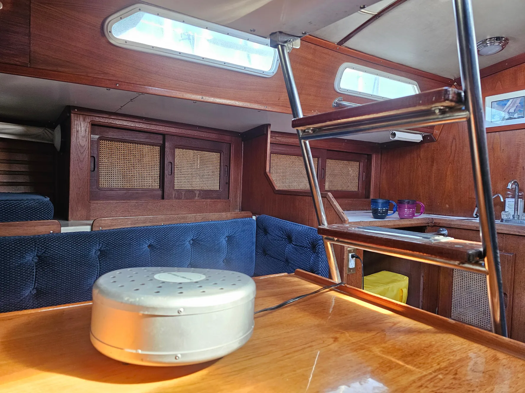 Interior of 1984 Schock NY 36 sailboat with wooden cabinetry and seating.