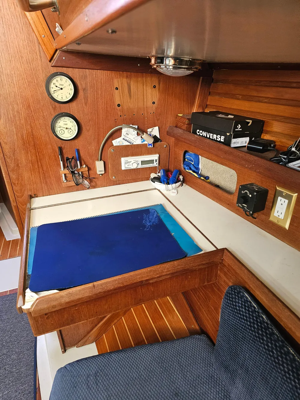 Interior of 1984 Schock NY 36 sailboat with navigation station and wooden cabinetry.