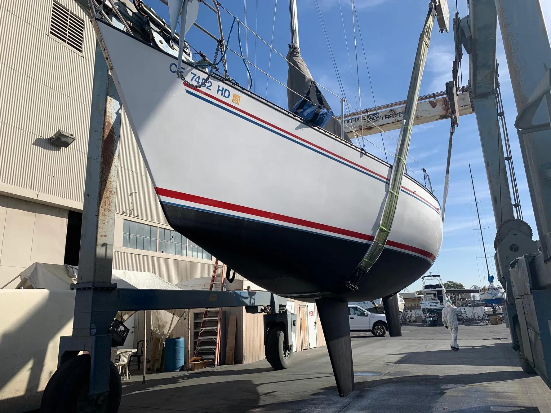 1984 Schock NY 36 sailboat in dry dock, suspended for maintenance.