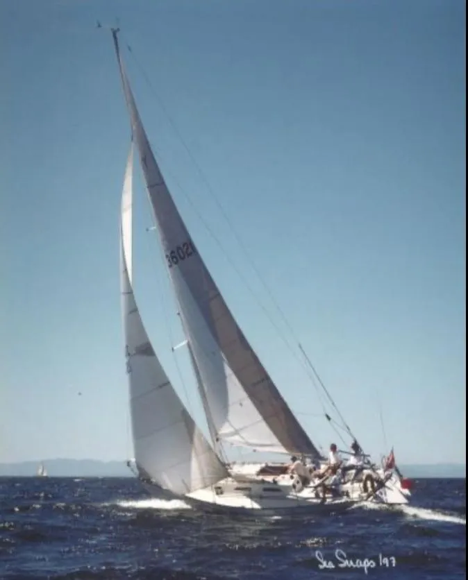 Sailing yacht Schock NY 36, 1984 model, gliding on open water under clear skies.