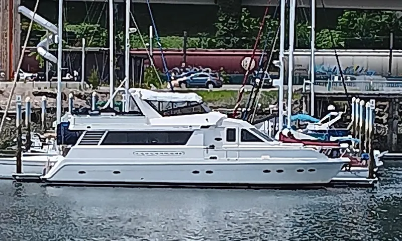 Lady Elaine Yacht Photos Pics 1993 Kha Shing Motoryacht docked in a marina, surrounded by other boats.