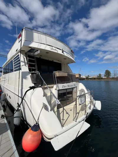 Lady Elaine Yacht Photos Pics 1993 Kha Shing Motoryacht docked under a partly cloudy sky.