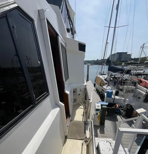 Lady Elaine Yacht Photos Pics 1993 Kha Shing Motoryacht docked at marina, side view with clear sky.