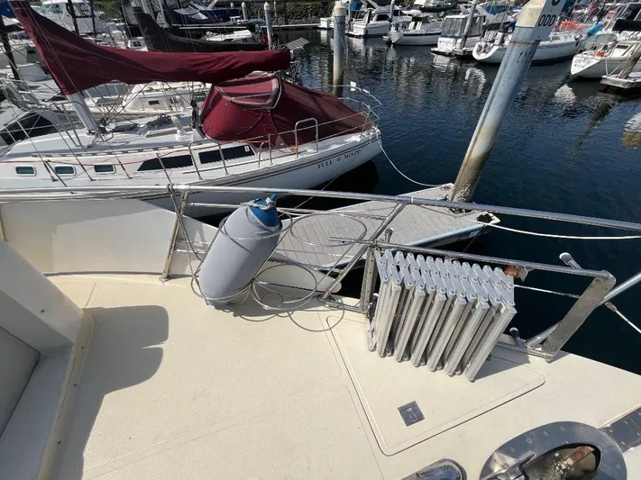 Lady Elaine Yacht Photos Pics 1993 Kha Shing Motoryacht docked, featuring deck view with nearby sailboats in marina.