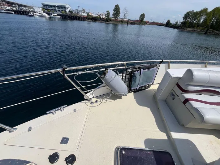 Lady Elaine Yacht Photos Pics 1993 Kha Shing Motoryacht deck with seating, docked by calm waters.