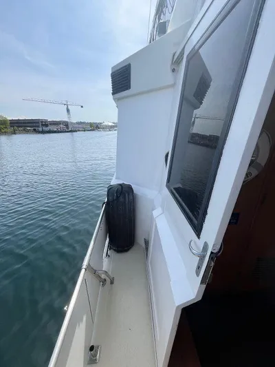 Lady Elaine Yacht Photos Pics 1993 Kha Shing Motoryacht deck view with water and crane in the background.