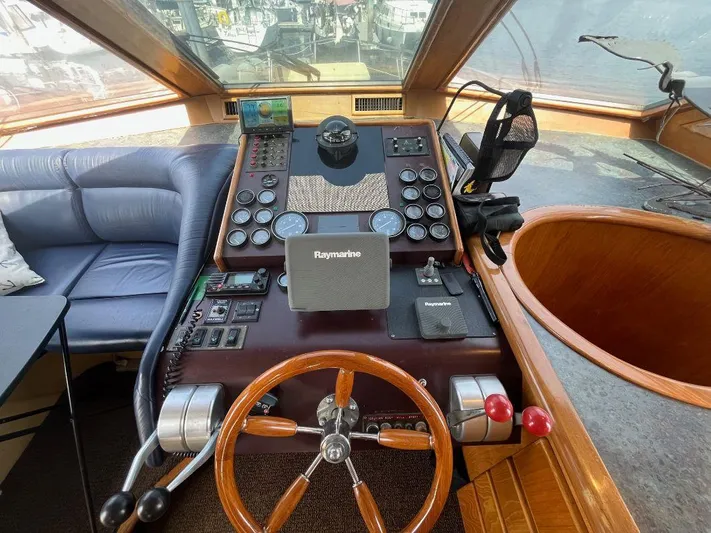 Lady Elaine Yacht Photos Pics Cockpit of 1993 Kha Shing Motoryacht with wooden steering wheel and navigation equipment.