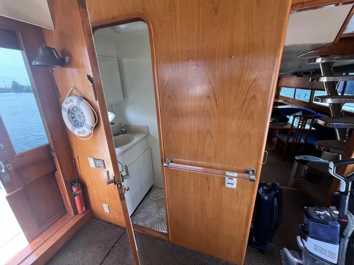 Lady Elaine Yacht Photos Pics Interior of 1993 Kha Shing Motoryacht with wooden paneling and compact bathroom.
