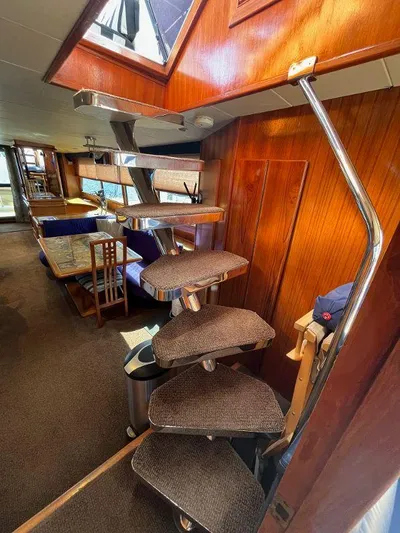 Lady Elaine Yacht Photos Pics Interior of 1993 Kha Shing Motoryacht with spiral staircase and dining area.