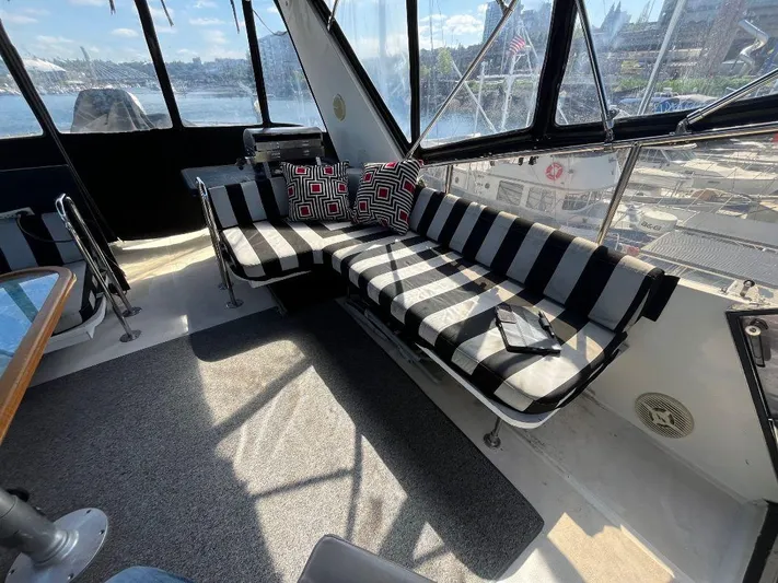 Lady Elaine Yacht Photos Pics Interior of 1993 Kha Shing Motoryacht with striped seating and scenic window views.