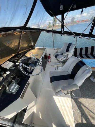 Lady Elaine Yacht Photos Pics 1993 Kha Shing Motoryacht helm with dual seats, overlooking serene waters.