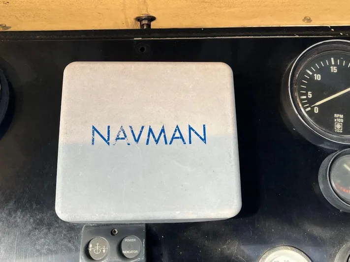Lady Elaine Yacht Photos Pics Navman device on 1993 Kha Shing Motoryacht dashboard with gauges and controls.