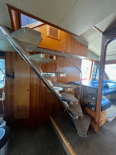 Lady Elaine Yacht Photos Pics Interior of 1993 Kha Shing Motoryacht with wooden stairs and seating area.