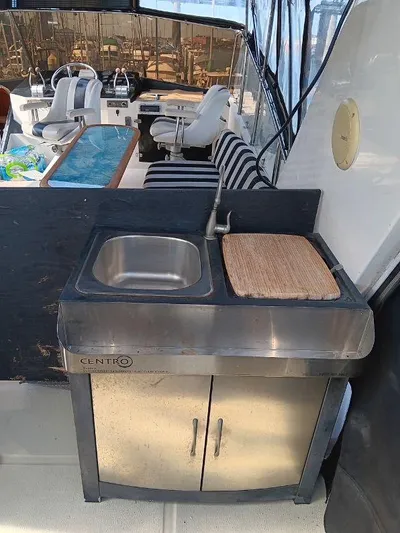 Lady Elaine Yacht Photos Pics Outdoor sink and counter on 1993 Kha Shing Motoryacht with striped seating in background.