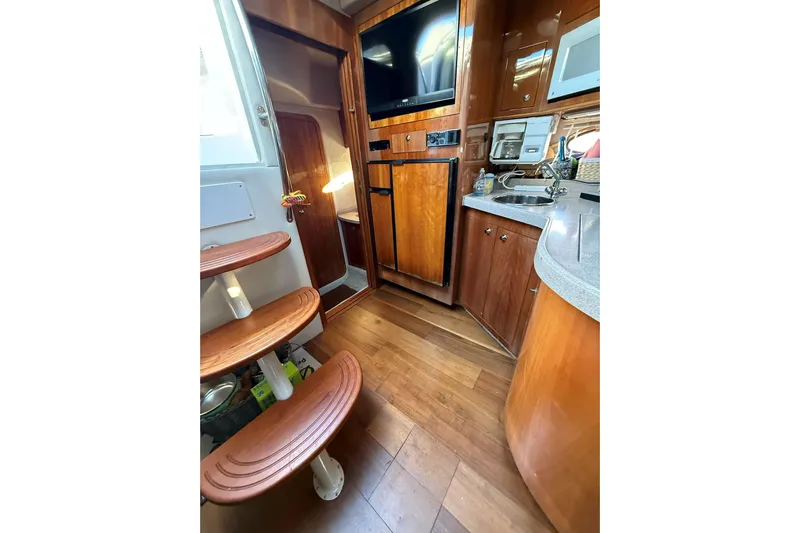 Amazing C's Yacht Photos Pics Interior of 2002 Regal Commodore 3860 yacht with wooden flooring and modern amenities.
