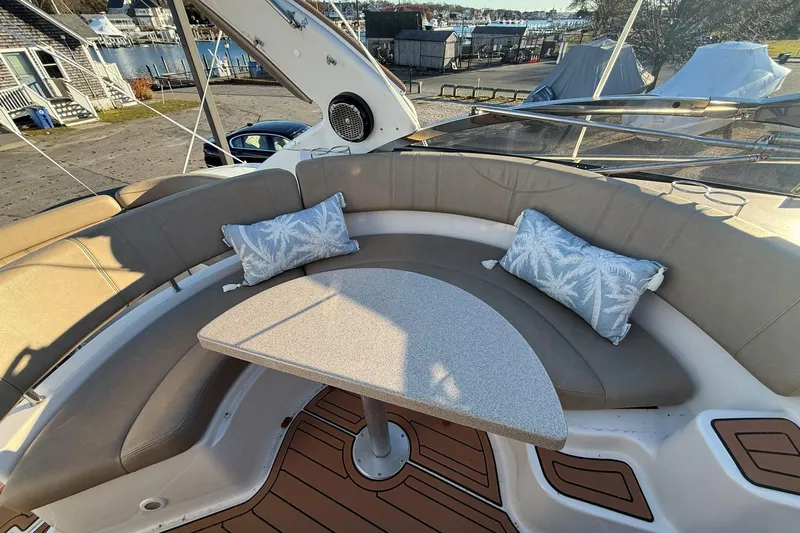 Amazing C's Yacht Photos Pics 2002 Regal Commodore 3860 boat interior with curved seating and decorative cushions.