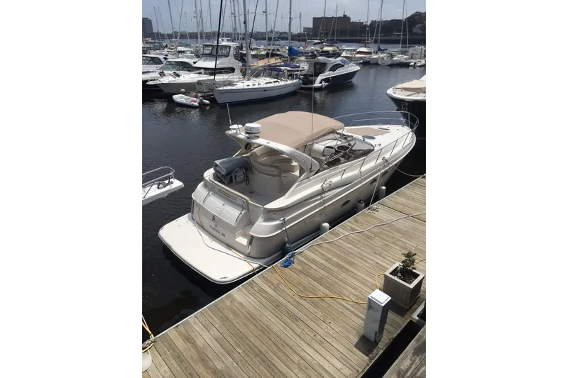 Amazing C's Yacht Photos Pics 2002 Regal Commodore 3860 yacht docked at marina, surrounded by other boats.