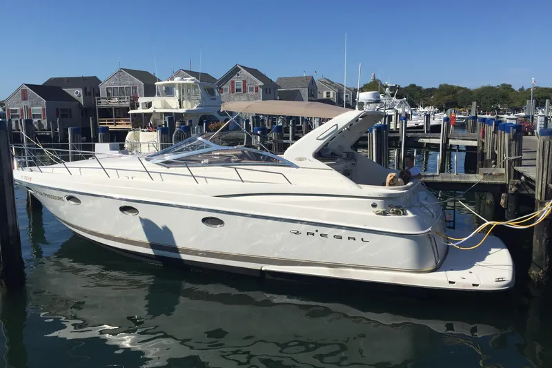 Amazing C's Yacht Photos Pics 2002 Regal Commodore 3860 yacht docked at a marina with waterfront homes in the background.