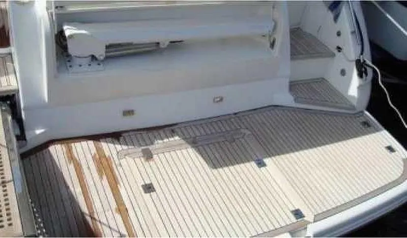  Yacht Photos Pics Teak deck of a 2004 Princess 65 yacht, showcasing elegant marine craftsmanship.