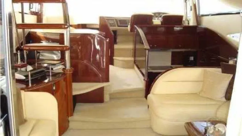  Yacht Photos Pics Luxurious interior of a 2004 Princess 65 yacht with elegant seating and wooden finishes.