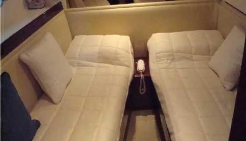  Yacht Photos Pics Twin beds in a 2004 Princess 65 yacht cabin with a phone between them.