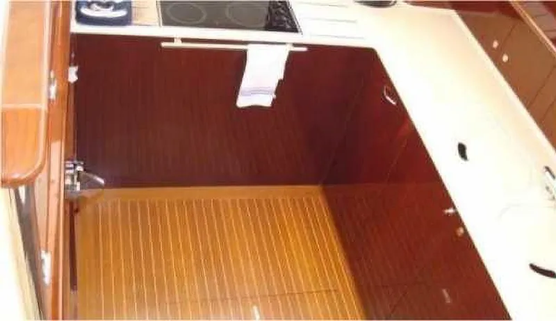  Yacht Photos Pics Luxurious kitchen interior of 2004 Princess 65 yacht with wooden cabinetry and modern appliances.