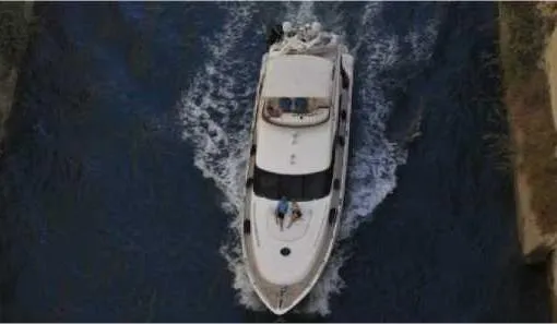  Yacht Photos Pics Overhead view of a 2004 Princess 65 yacht navigating through a narrow waterway.